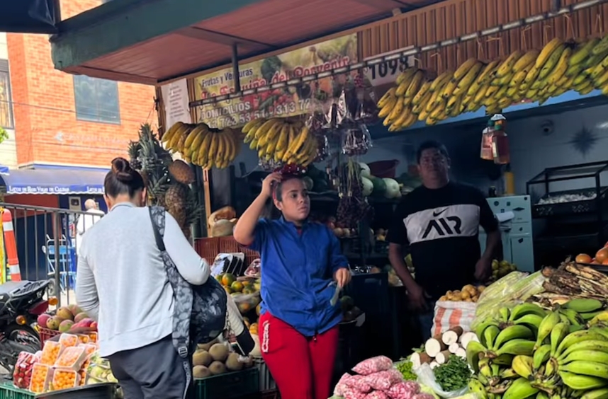 Fresh produce stall at a local Cartagena market with prices marked in Colombian pesos